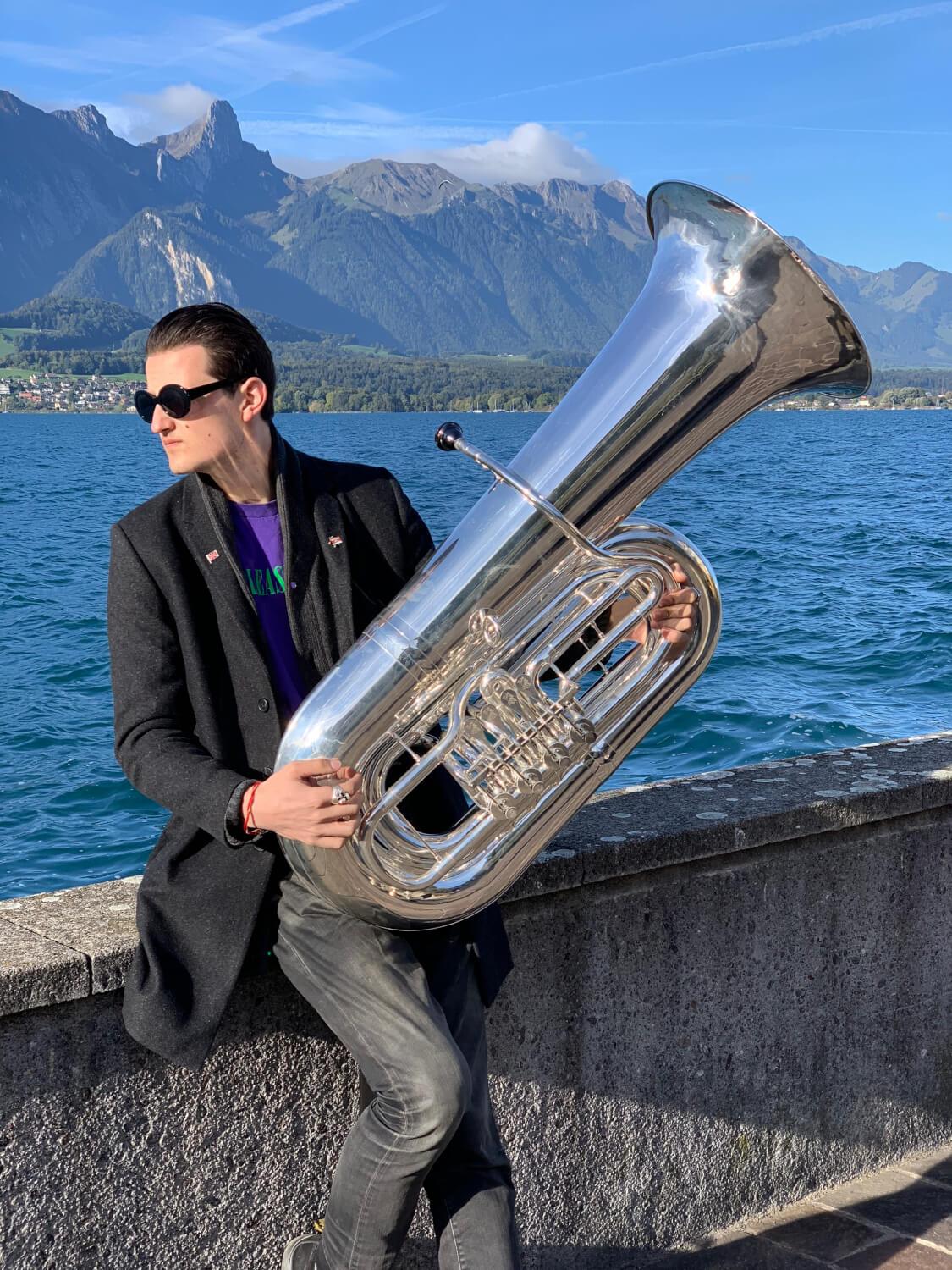 An image of Will Druiett holding a BBb 6/4 Rotary tuba ‘Kaiser’ from Wessex Tubas